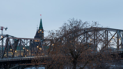 Parliament Hill, the Peace Tower are seen in the early morning behind a truss bridge in Canada's capital city, Ottawa.