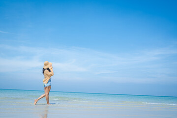 Fototapeta na wymiar Happy carefree woman enjoying beautiful sea on the beach,Summer holidays concept.