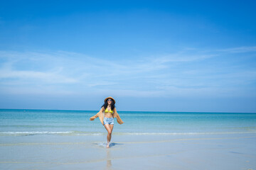 Happy woman playful on paradise tropical beach having fun in freedom,Beautiful girl on travel vacation.