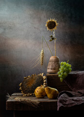 Still life with sunflowers, grapes and pears