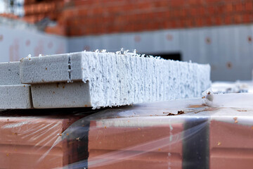 Wall insulation with polystyrene foam. Insulation and waterproofing of the underground part of the building. Wall protection and heat preservation in the house. Insulation of the facade of the house.