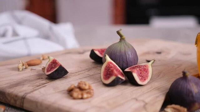 Sliced fig fruiton a wooden cutting board board at domestic kitchen