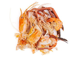 Shrimp heads and shrimp shells, food waste, leftovers, waste. Natural seafood. Lunch. Dinner isolated on white background.