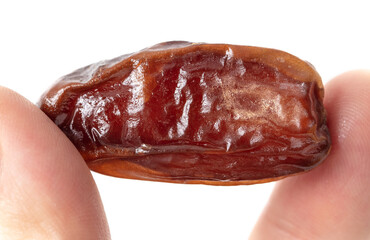 Dried date in hand isolated on white background.