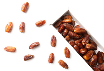 Dried dates in a box isolated on a white background.