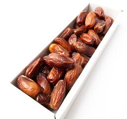 Dried dates in a box isolated on a white background.
