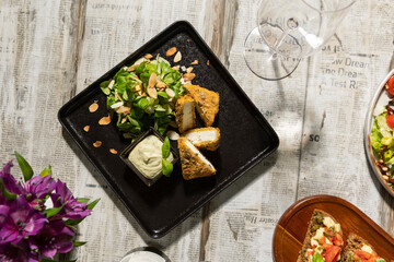 Turkey in hazelnut crust on a plate with dip