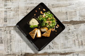 Turkey in hazelnut crust on a plate with dip