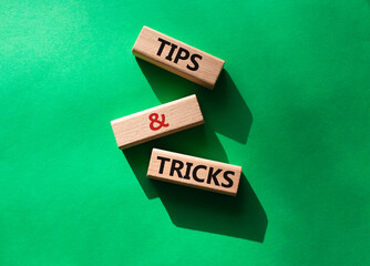 Tips and tricks symbol. Wooden blocks with words Tips and tricks. Beautiful green background....
