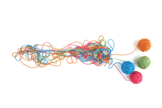 Tangled colorful cotton threads and balls isolated on white background. Abstract thread lines chaos pattern.