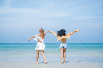 Two women in summer casual clothes play in the sea on vacation,Concept vacation,Holiday in summer.