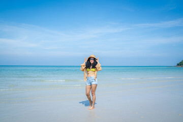 Fototapeta na wymiar Happy woman playful on paradise tropical beach having fun in freedom,Beautiful girl on travel vacation.