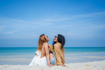 People spending time at the beautiful beach,Happy female friends enjoy activity on holiday travel vacation at the sea,Having Fun,Summer Lifestyle,Nice weather in travel and holiday concept.