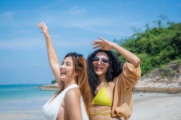 Two Asian beautiful girls happy together on the beach,Holiday in summer.
