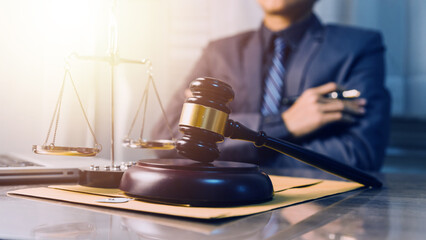 Business and lawyers discussing contract papers with brass scale on desk in office. Law, legal services, advice, justice and law concept picture with film grain effect