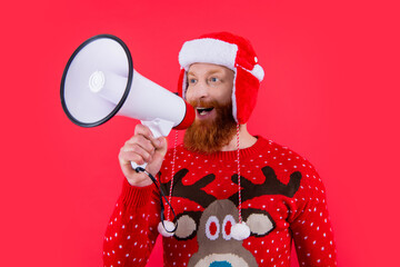 merry christmas. happy man announcing in loudspeaker about christmas sales. man at christmas