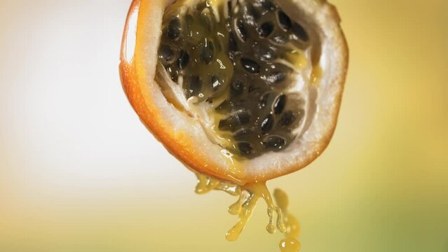 Slow Motion Macro Shot of Flowing Granadilla Juice from Halved Granadilla
