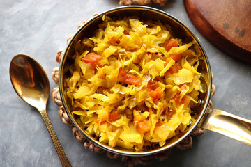 Stir fried Cabbage Salad or patta gobi ki sabzi. served in a bowl over moody background, Copy space.