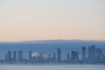 Fototapeta na wymiar A thick fog blanket covering Metro Vancouver on a winter morning during sunrise in Burnaby, British Columbia, Canada