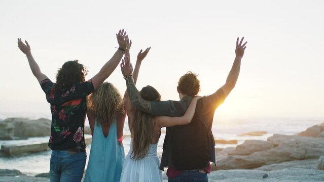 Back, group of friends and beach with sunset, excited and enjoy vacation together. Young people, seaside holiday and adventure to relax, fun or travel for view, weekend break or celebration for peace