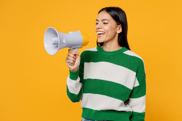 Young latin woman wear casual cozy green knitted sweater hold scream aside in megaphone announces...