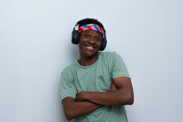 young handsome man wearing shirt listening to music on an headphone