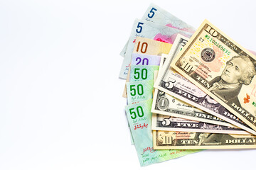 Maldives banknotes and dollar banknotes arranged in a chaotic manner. Group of money maldives and dollar banknotes on a white background and space for text. Exchange money, travel concept.