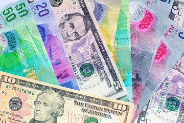 Maldives banknotes and dollar banknotes arranged in a chaotic manner. Group of money maldives and dollar banknotes on a white background and space for text. Exchange money, travel concept.