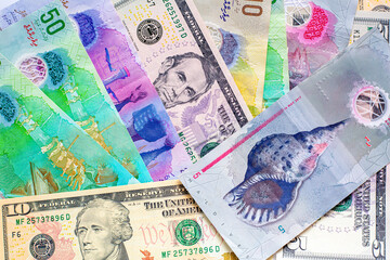 Maldives banknotes and dollar banknotes arranged in a chaotic manner. Group of money maldives and dollar banknotes on a white background and space for text. Exchange money, travel concept.