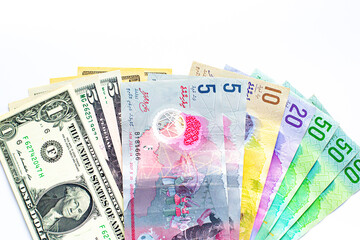 Maldives banknotes and dollar banknotes arranged in a chaotic manner. Group of money maldives and dollar banknotes on a white background and space for text. Exchange money, travel concept.