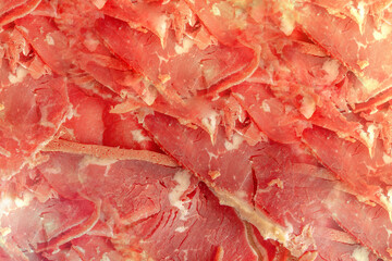 Turkish pastrami. Bacon made from ribeye meat. Beef pastrami sliced Pastirma or Turkish pastrami. Close-up.