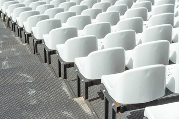 Fototapeta premium Seats of tribune on sport stadium. Concept of fans, chairs for audience, cultural environment concept. mpty seats, modern stadium.