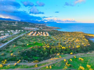 Obraz premium Sunset with green field which is land for real estate in Esentepe, North Cyprus