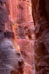 Fototapeta na wymiar Al Siq Canyon in Petra, Jordan, pink red sandstone walls both sides