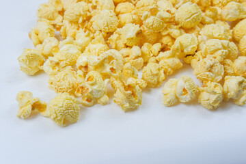 Butter Popcorn scattered on a white background