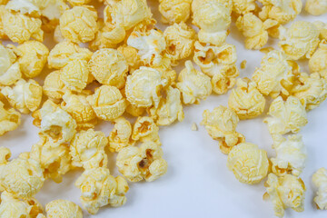 Butter Popcorn scattered on a white background