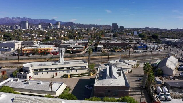 Wide panning aerial shot of downtown Glendale, California as the Amtrak train passes by. 4K
