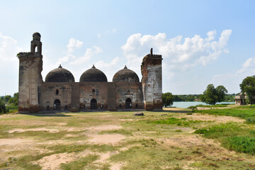 Fototapeta na wymiar Alif Khan Masjid, rear view, build in 1325 AD, a brick structure, with 3 domes, each of 100 square feet with echo effect, Dholka, Gujrat, India