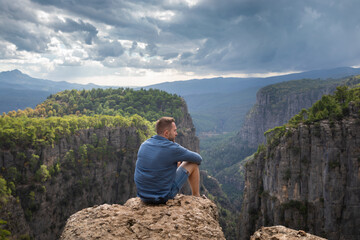 The man in the Tazi Canyon admiring the surrounding mountain landscape