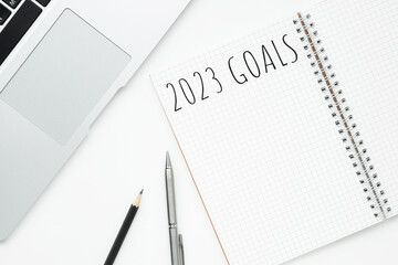 Notebook with 2023 goals text on it to apply new year resolutions and plan.