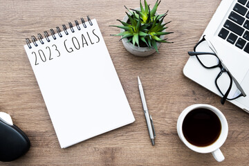 Notebook with 2023 goals text on it to apply new year resolutions and plan.