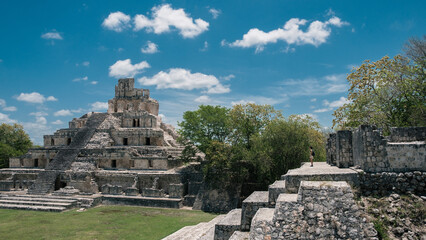 Woman staring in front of the ruins of the mayas pyramids at Edzna, Yucatan 