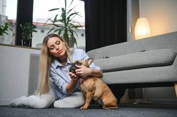 Obraz premium Young woman with her cute dog at home. Lovely pet