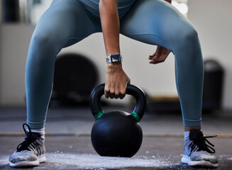 Obraz na płótnie Canvas Woman hand, kettlebell and gym floor in training, fitness or muscle development with smartwatch. Bodybuilder girl, weightlifting and strong with sneakers, chalk powder and focus on exercise in studio