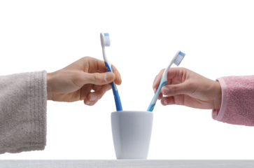 Man and woman taking their toothbrushes