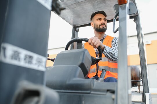 Man working at warehouse and driving forklift