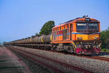 Tanker-freight train by diesel locomotive on the railway.