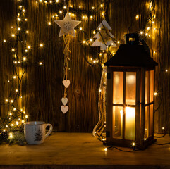 christmas lights and decorations on wooden background