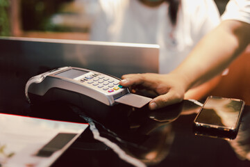 Man using credit card reader to enter PIN code.