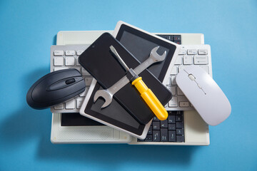 Wrench, screwdriver with a computer keyboard, smartphone, tablet, mouse. IT Service. Support